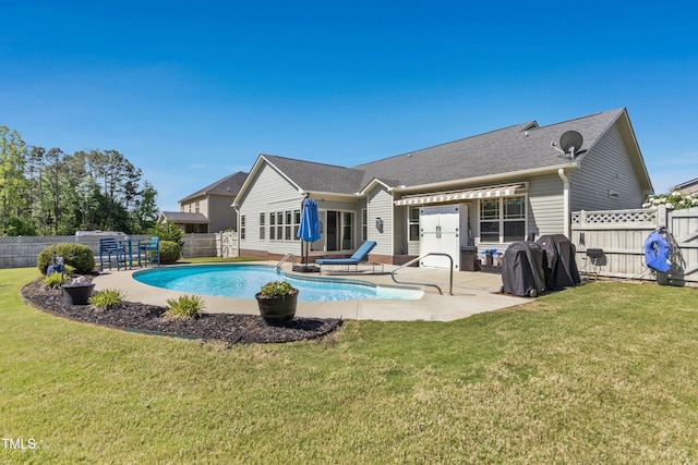 back of property featuring a fenced backyard, a fenced in pool, a lawn, and a patio area