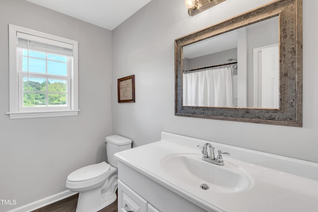 640 Short Journey Rd, Smithfield, NC 27577 - full bathroom with a shower with curtain, wood finished floors, vanity, baseboards, and toilet