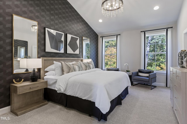 bedroom with multiple windows, light carpet, baseboards, and a notable chandelier