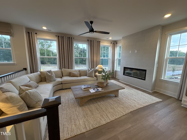 5906 Dunzo Dr, Raleigh, NC 27617 - living room with a ceiling fan, wood finished floors, a tiled fireplace, and recessed lighting