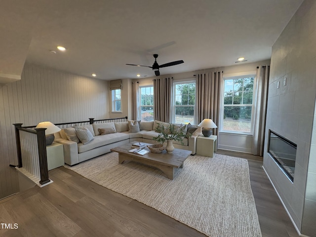 5906 Dunzo Dr, Raleigh, NC 27617 - living room with dark wood-style floors, ceiling fan, a tiled fireplace, and recessed lighting