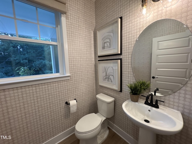 5906 Dunzo Dr, Raleigh, NC 27617 - half bathroom with toilet and wood finished floors