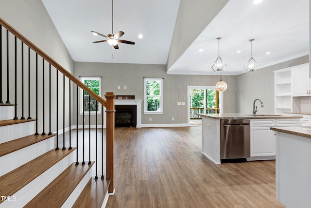 kitchen with a sink, ceiling fan, dishwasher, and white cabinets