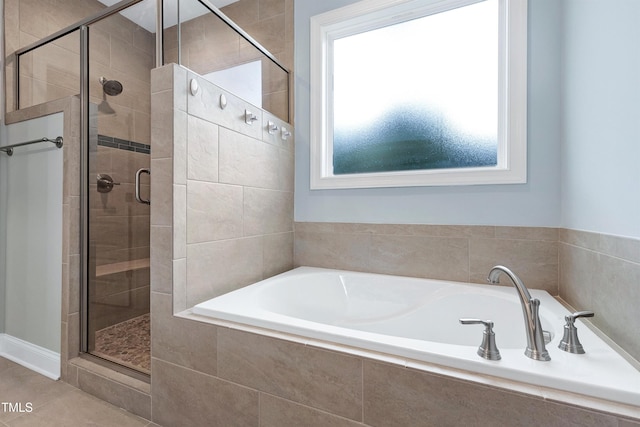 full bath featuring tile patterned floors, a stall shower, and a garden tub