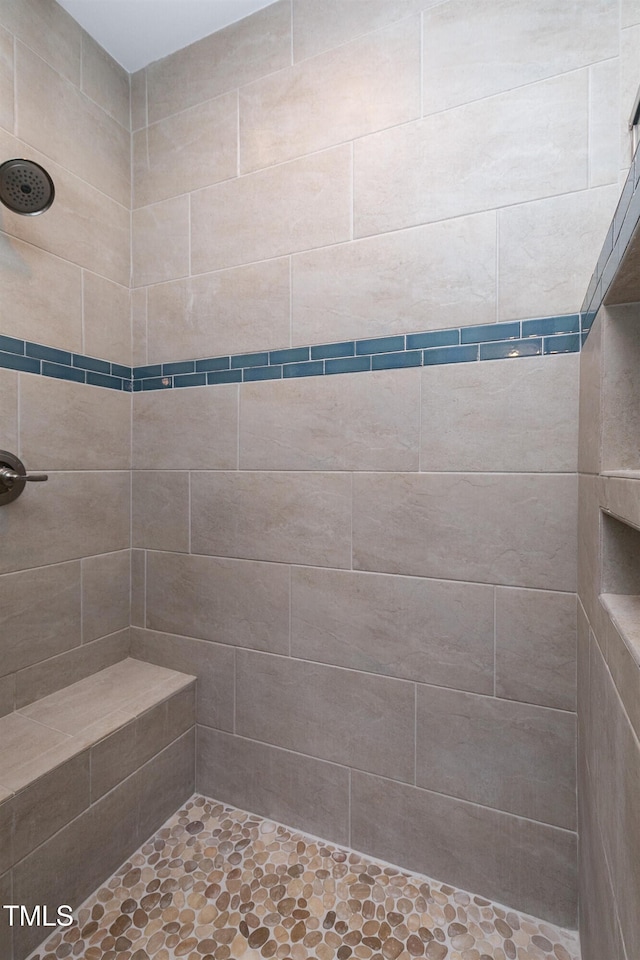 bathroom with tiled shower