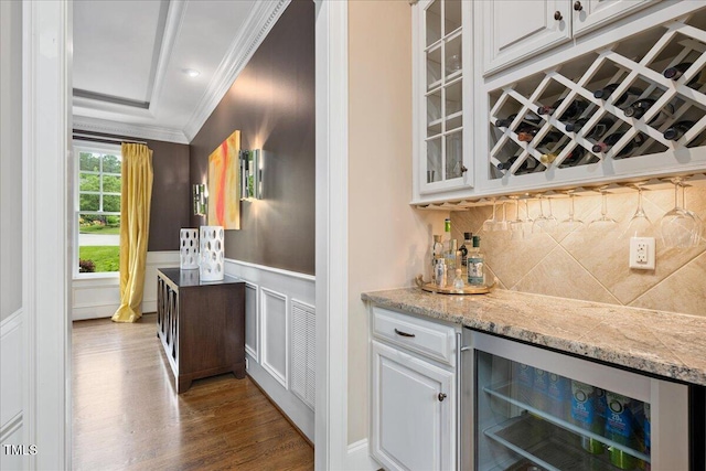 3601 Nightfall Ct, Raleigh, NC 27607 - indoor dry bar featuring beverage cooler, crown molding, wood finished floors, wainscoting, and a decorative wall