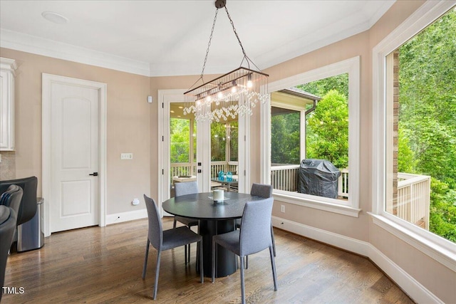 3601 Nightfall Ct, Raleigh, NC 27607 - dining room with healthy amount of natural light, wood finished floors, baseboards, and a chandelier