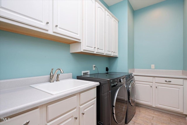 3601 Nightfall Ct, Raleigh, NC 27607 - laundry room featuring cabinet space, washing machine and dryer, and light wood-style flooring