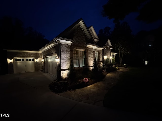 3601 Nightfall Ct, Raleigh, NC 27607 - view of front of house featuring concrete driveway, stone siding, and a garage