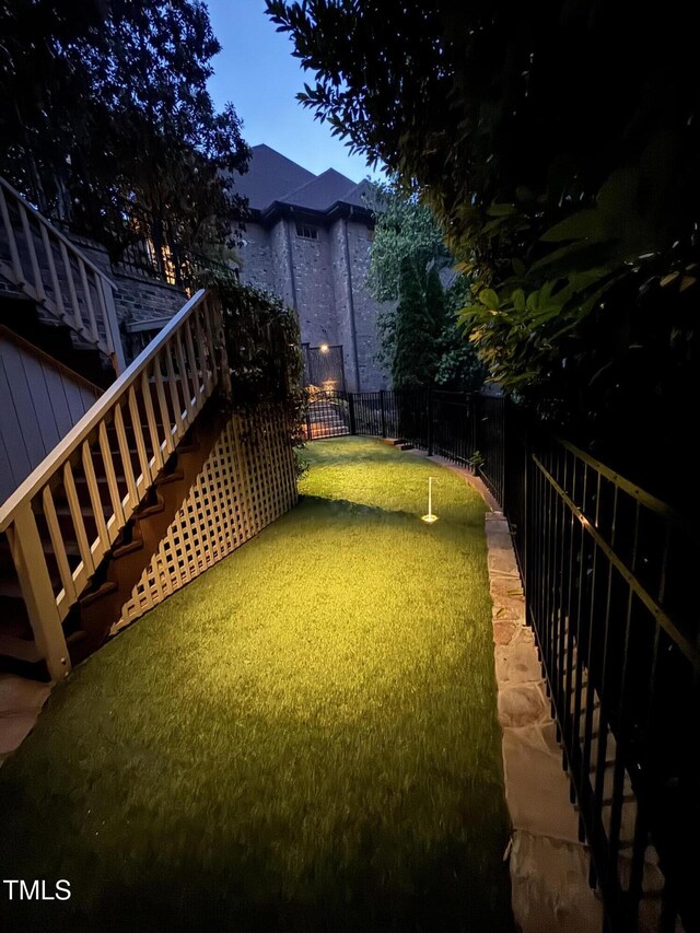 3601 Nightfall Ct, Raleigh, NC 27607 - view of yard with stairway, fence, and an area to practice putting