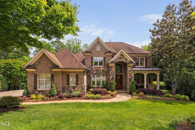 3601 Nightfall Ct, Raleigh, NC 27607 - view of front facade featuring a front yard, stone siding, and brick siding