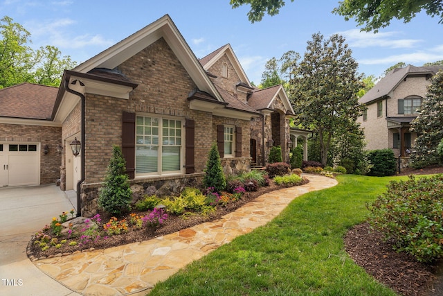 3601 Nightfall Ct, Raleigh, NC 27607 - view of home's exterior with stone siding, a lawn, a shingled roof, and an attached garage