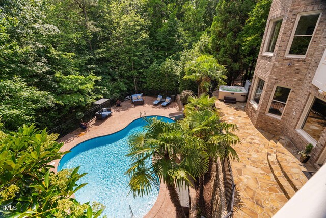 3601 Nightfall Ct, Raleigh, NC 27607 - view of pool with a hot tub, a patio area, and a fenced backyard