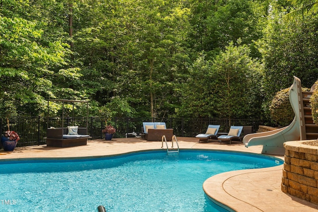 3601 Nightfall Ct, Raleigh, NC 27607 - view of pool with a water slide, fence, and a forest view