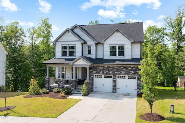 521 Marion Hills Way, Knightdale, NC 27545 - craftsman house featuring a front lawn, an attached garage, stone siding, a porch, and driveway