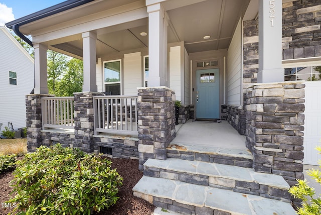 521 Marion Hills Way, Knightdale, NC 27545 - doorway to property featuring covered porch and stone siding