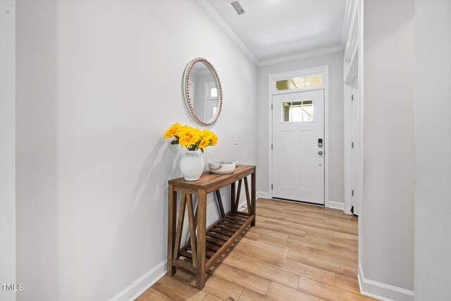 521 Marion Hills Way, Knightdale, NC 27545 - foyer entrance with baseboards, ornamental molding, light wood finished floors, and visible vents