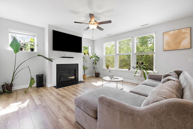 521 Marion Hills Way, Knightdale, NC 27545 - living area featuring a ceiling fan, baseboards, visible vents, and a fireplace with flush hearth