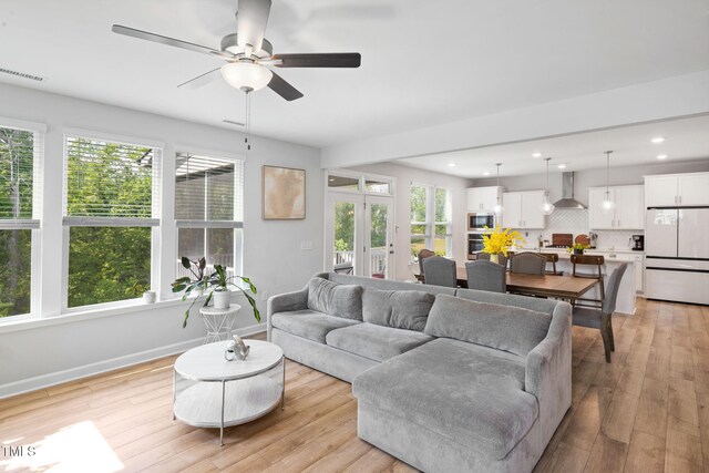 521 Marion Hills Way, Knightdale, NC 27545 - living room featuring plenty of natural light, a ceiling fan, visible vents, and light wood-type flooring