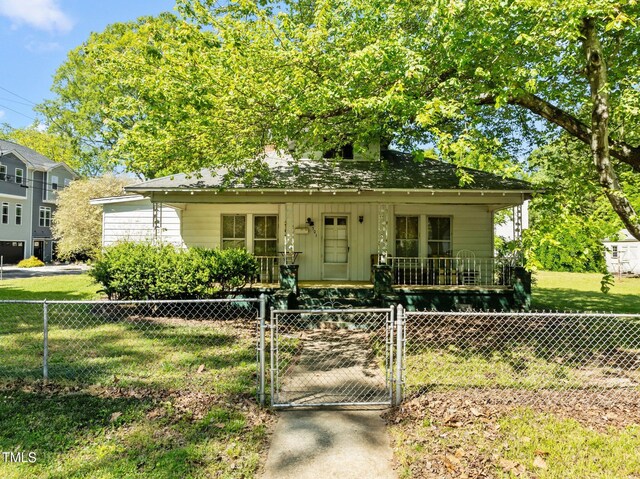 301 N W St, Cary, NC 27513 - view of front of house featuring a gate, board and batten siding, fence private yard, and a front yard