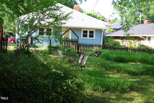 1013 Green St, Durham, NC 27701 - rear view of house with fence and a chimney