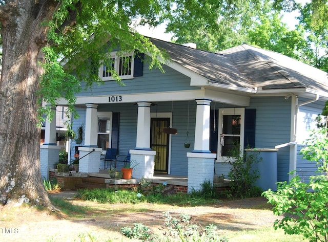 1013 Green St, Durham, NC 27701 - view of front of house with roof with shingles, a porch, and brick siding