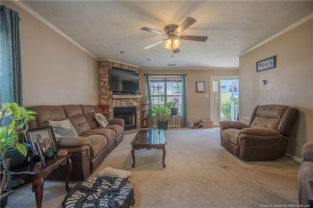 carpeted living area featuring a fireplace, ceiling fan, ornamental molding, and a textured ceiling
