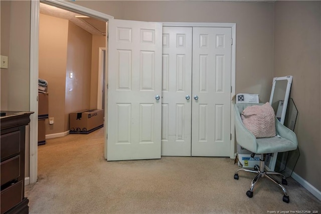 home office featuring baseboards and carpet flooring