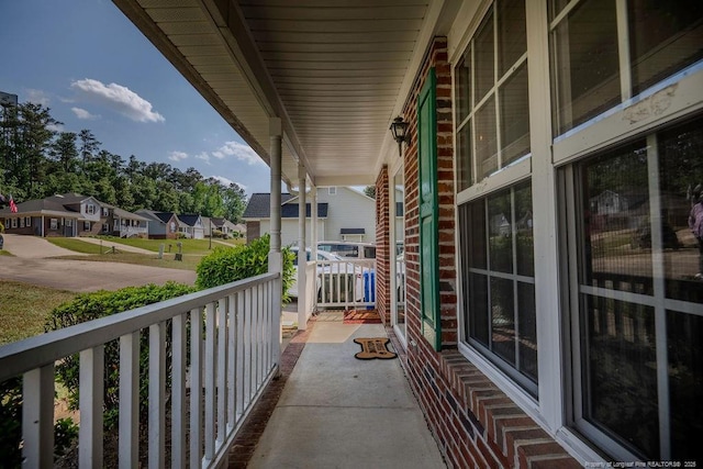 balcony featuring a porch and a residential view