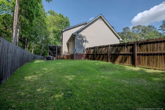 view of yard with a fenced backyard
