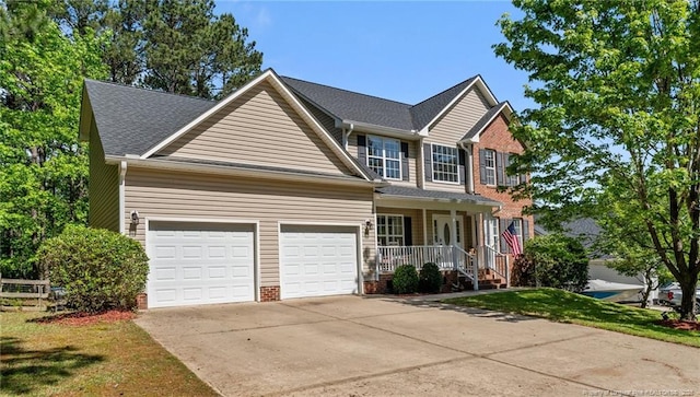 craftsman inspired home featuring covered porch, driveway, a front lawn, and a garage