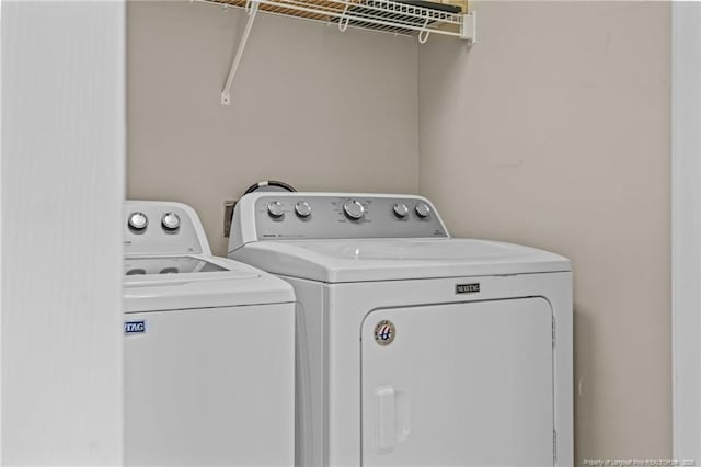 washroom featuring separate washer and dryer and laundry area