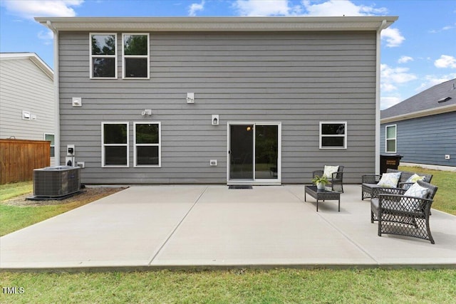 back of property featuring an outdoor living space, a patio area, central AC, and fence