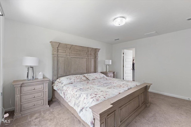 bedroom with baseboards, light carpet, and visible vents