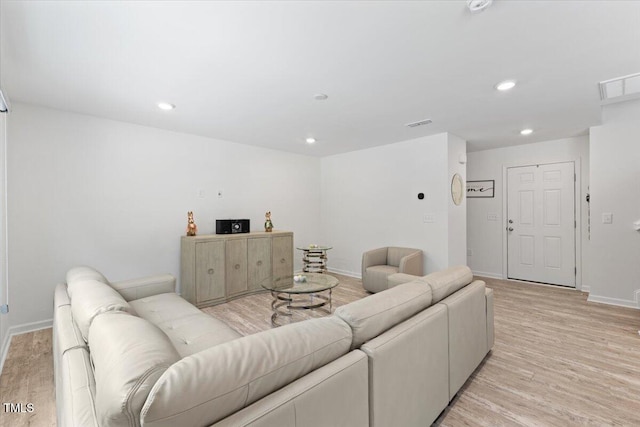 living area featuring recessed lighting, baseboards, visible vents, and light wood finished floors