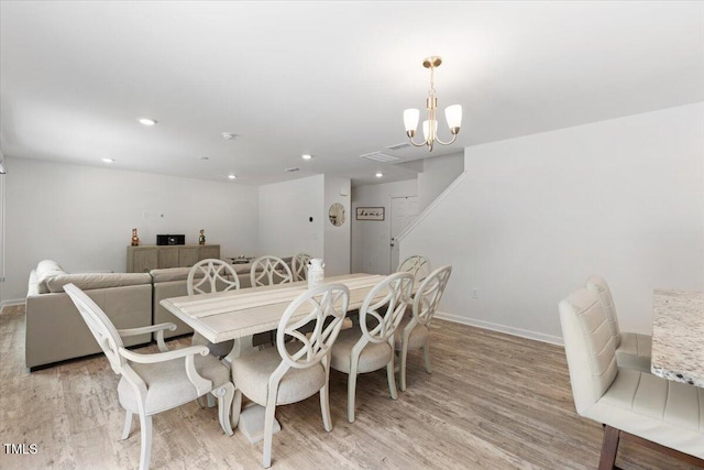 dining room with baseboards, recessed lighting, light wood-style flooring, and a notable chandelier