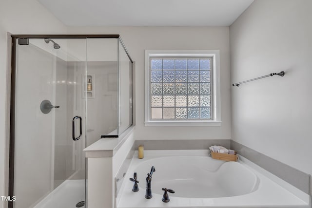 full bathroom with a garden tub and a shower stall