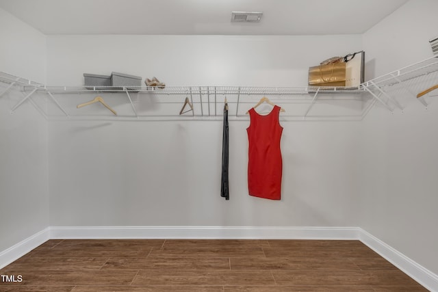 spacious closet featuring wood finished floors and visible vents