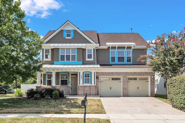 craftsman inspired home with covered porch, driveway, a garage, brick siding, and a shingled roof