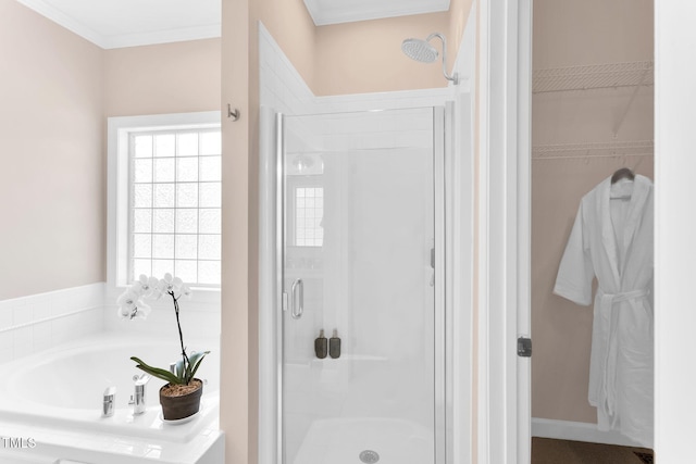 205 Carlyle Cir, Goldsboro, NC 27530 - bathroom with a shower stall, a bath, a spacious closet, and crown molding