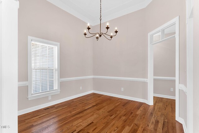 205 Carlyle Cir, Goldsboro, NC 27530 - unfurnished dining area with a chandelier, wood finished floors, and baseboards