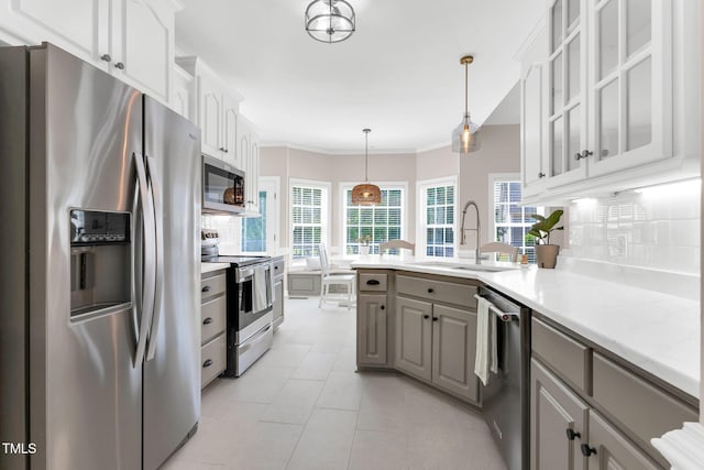 205 Carlyle Cir, Goldsboro, NC 27530 - kitchen with stainless steel appliances, a sink, a peninsula, light countertops, and glass insert cabinets