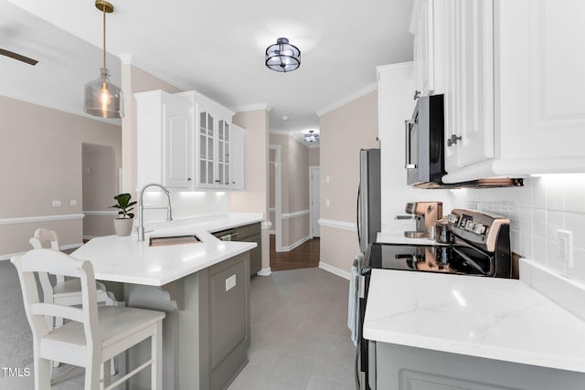 205 Carlyle Cir, Goldsboro, NC 27530 - kitchen featuring a sink, stainless steel appliances, a kitchen breakfast bar, a peninsula, and glass insert cabinets
