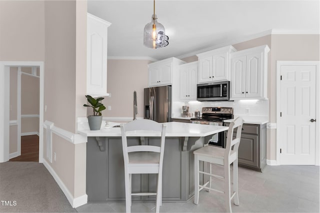 205 Carlyle Cir, Goldsboro, NC 27530 - kitchen featuring stainless steel appliances, a kitchen bar, a peninsula, light countertops, and backsplash