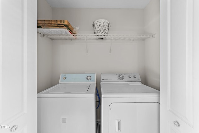 washroom with washing machine and dryer and laundry area