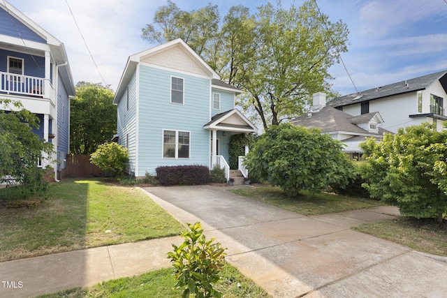view of front of house with a front lawn and fence