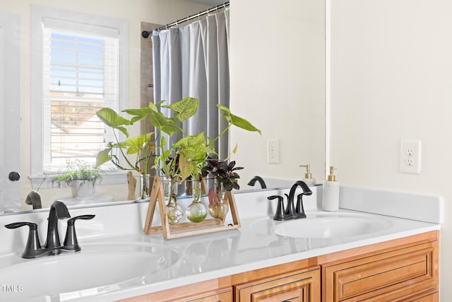bathroom with a sink and double vanity