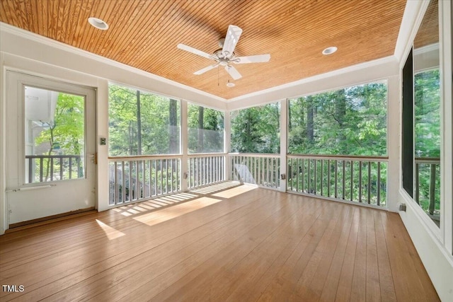 unfurnished sunroom featuring a ceiling fan