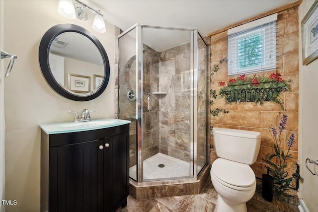 bathroom featuring toilet, visible vents, a shower stall, and vanity