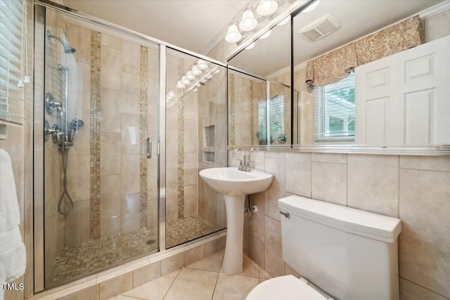full bathroom featuring visible vents, toilet, tile walls, tile patterned floors, and a stall shower